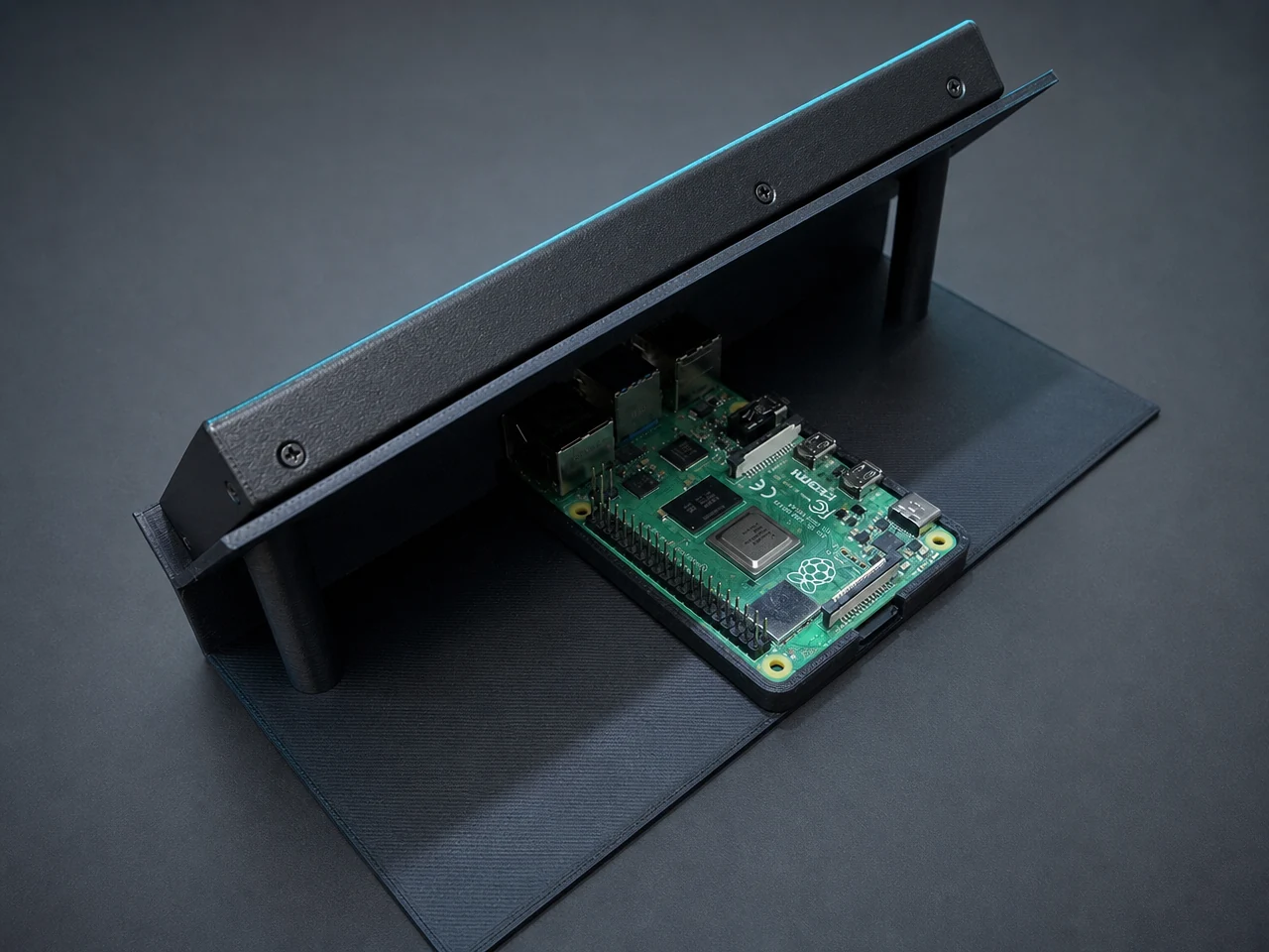 Inside the Salati Prayer Mat prototype: a single-board computer mounted beside a custom 3D-printed frame that holds the wide display at a reading angle
